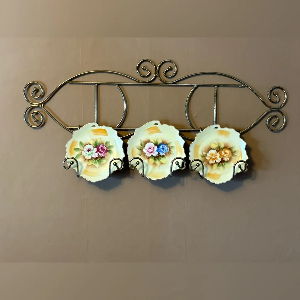 vintage hand-painted Japanese decorative plates on a brass wall-mounted display